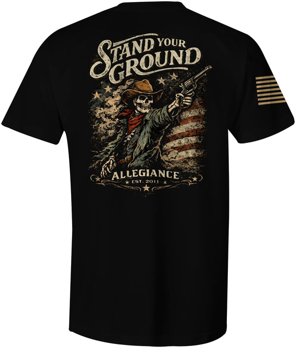 Stand Your Ground patriotic western t shirt featuring skeleton cowboy with revolver in front of distressed American flag graphic on black tee